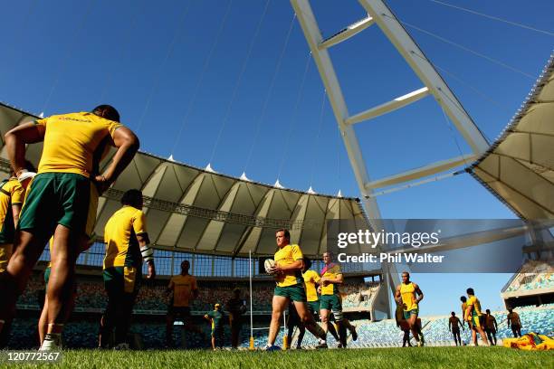 Ben Alexander of the Wallabies runs the ball during an Australian Wallabies training session at the Moses Mabhida Stadium on August 10, 2011 in...