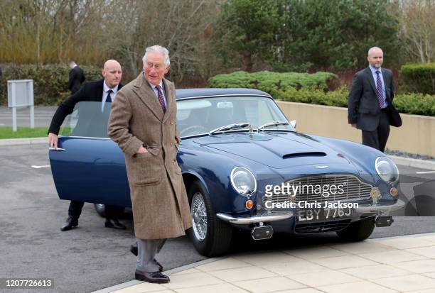 Prince Charles, Prince of Wales arrives in his Aston Martin DB6 Volante, which is powered by surplus wine, to visit the new Aston Martin Lagonda...