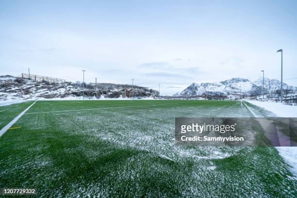 soccer field in winter - snow on grass stock pictures, royalty-free photos & images
