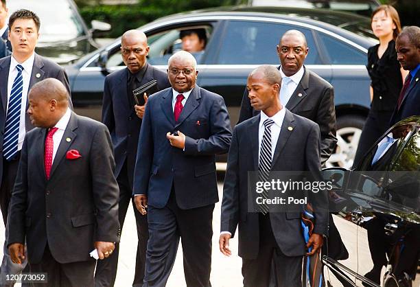 President of Mozambique Armando Guebuza walks, escorted by security in Zhongnanhai, shortly before meeting with Chinese Premier Wen Jiabao at the...