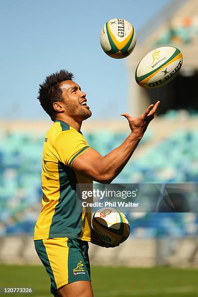 Digby Ioane of the Wallabies juggles rugby balls during an Australian Wallabies training session at the Moses Mabhida Stadium on August 10, 2011 in...