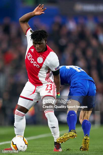 Cucurellaof Getafe CF competes for the ball with Lassina Traore of AFC Ajax during the UEFA Europa League round of 32 first leg match between Getafe...