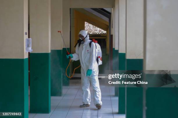 Worker sprays disinfectant to prevent the spread of COVID-19 in a school in Cibinong, Bogor, West Java, Indonesia, on Thursday, March 19, 2020. The...