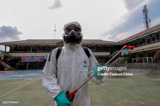 Worker sprays disinfectant to prevent the spread of COVID-19 in a school in Cibinong, Bogor, West Java, Indonesia, on Thursday, March 19, 2020. The...