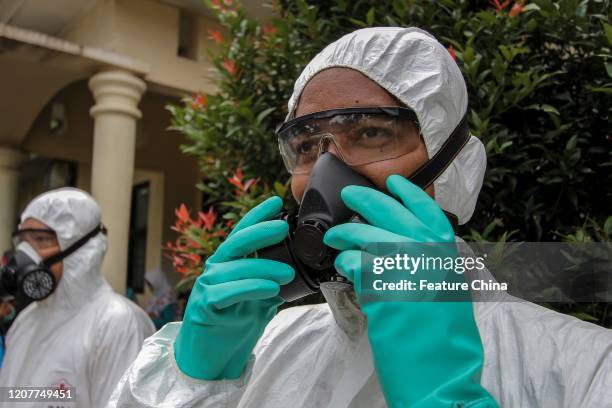 Workers getting prepared to disinfect a school to prevent the spread of COVID-19 in Cibinong, Bogor, West Java, Indonesia, on Thursday, March 19,...