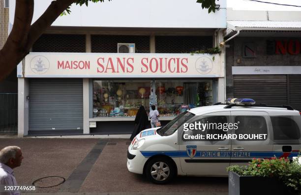 French police patrol in a street of Saint-Denis-de-la-Reunion, on March 19, 2020 on the French overseas department of La Reunion, after authorities...