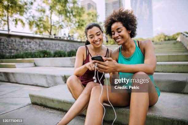 girlfriends taking a break on morning exercise routine - muscle black wallpaper stock pictures, royalty-free photos & images