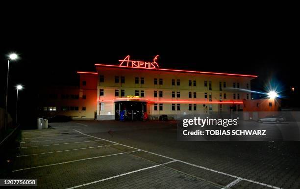 An exterior night view taken on March 19, 2020 shows the almost empty paking place in front of Berlin's Artemis brothel as many activities came to a...