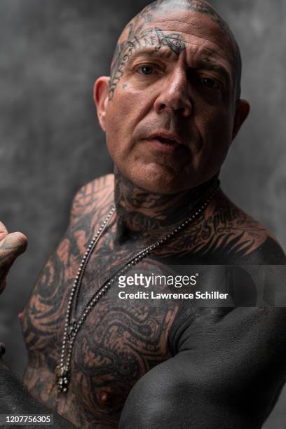 Portrait of Evan Seinfeld as he shows the tattoos on his face, chest, and arm, Los Angeles, California, July 16, 2019. In addition to several...