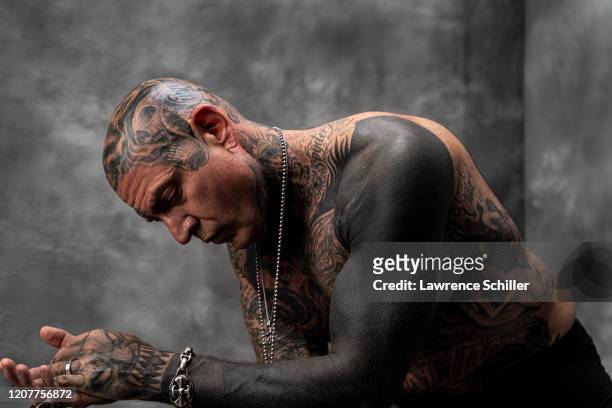 Portrait of Evan Seinfeld as he shows the tattoos on his head, arms, and torso, Los Angeles, California, July 16, 2019. In addition to several...