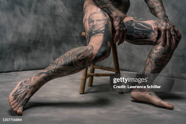 Close-up of retired executive Charles Venancio's tattooed hands and legs, New York, New York, June 20, 2019. He wears leg pieces by Bob Tyrrell, Carl...