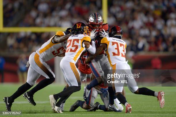 Roman Tatum and Arrion Springs of the LA Wildcats tackle Sammie Coates of the Houston Roughnecks during the XFL game at TDECU Stadium on February 8,...