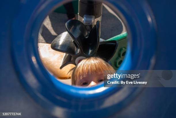 two year old boy playing - bullauge stock-fotos und bilder