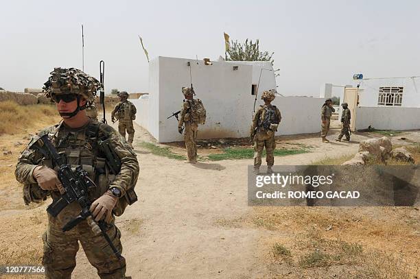 Troops from the Battle Co., 1-32 Infantry Battalion, 3rd Brigade Combat Team accompanied by Afghan National Army soldiers inspect the Mullah Omar...