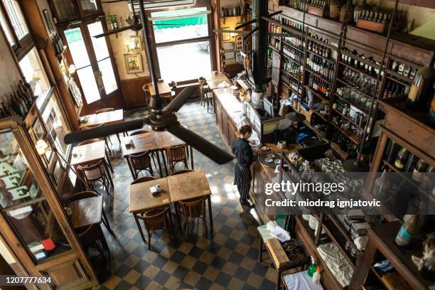 waitress setting things up before start of working day in traditional coffee shop in buenos aires - buenos-aires imagens e fotografias de stock