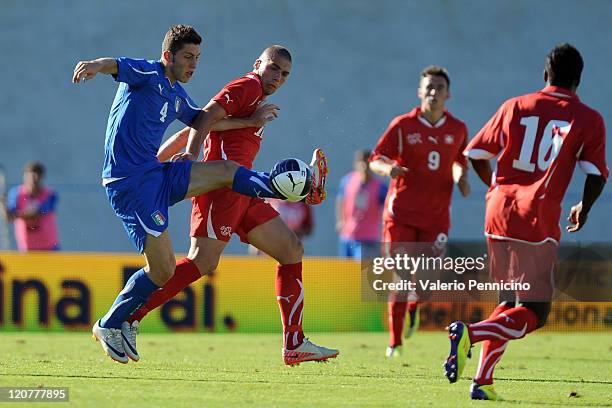 Luca Marrone of Italy U21 competes for the ball with Pajtim Kasami of Switzerland U21 during the international friendly match between Italy U21 and...