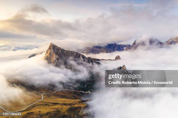 giau pass, ra gusela, cinque torri dolomiti alps covered by clouds, aerial view, italy - glen stock-fotos und bilder