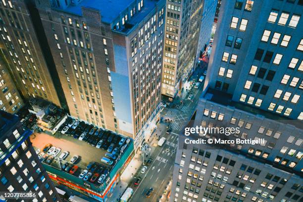 high angle view of high rise buildings over 7th ave at night, new york city - manhattan stock pictures, royalty-free photos & images