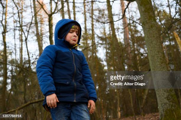 little pouting boy in the forest  disgusted, yelling. - painful lips stock pictures, royalty-free photos & images