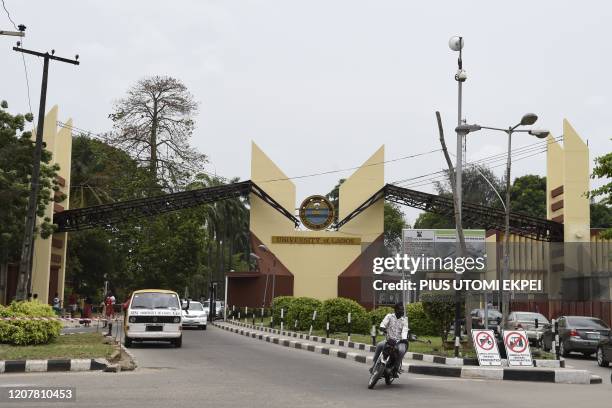 Vehicles are seen at the entrance of the University of Lagos, in Lagos, on March 20, 2020. - The Nigerian government has closed all federal schools...