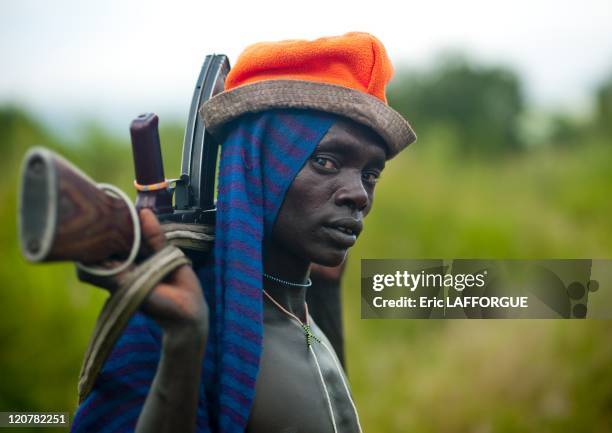 Suri man with a Kalashnikov in Omo valley, Ethiopia on July 05, 2010 - Surma or Suri are sedentary pastoral people living in south west of Ethiopia,...