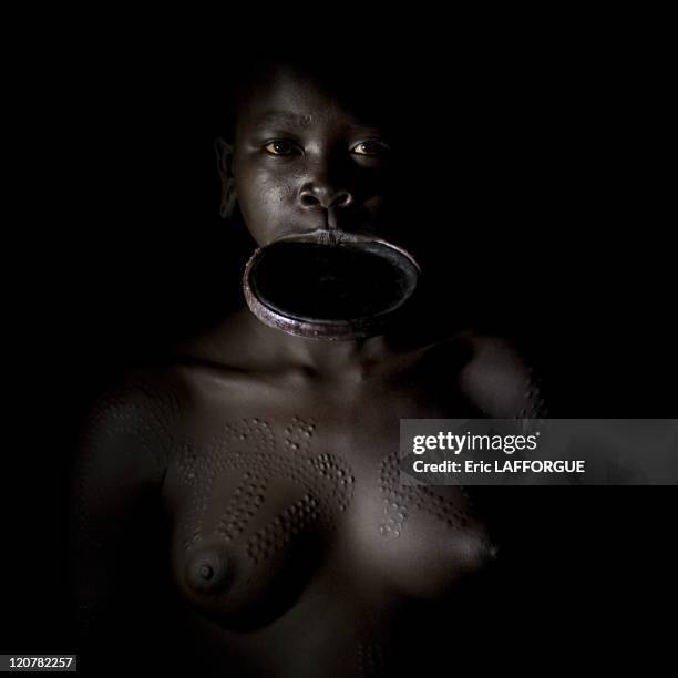 Surma woman with lip plate in Turgit village, Omo valley, Ethiopia on July 04, 2010 - Piercing and lip plates are a strong part of the Suri culture....