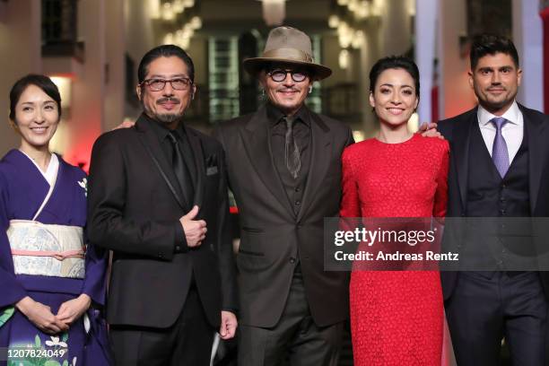 Akiko Iwase, Hiroyuki Sanada, Johnny Depp, Minami and director Andrew Levitas pose at the "Minamata" premiere during the 70th Berlinale International...