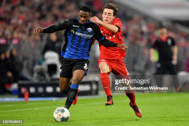 Christopher Antwi-Adjej of SC Paderborn and Alvaro Odriozola of FC Bayern Munchen battle for possession during the Bundesliga match between FC Bayern...