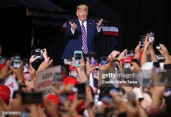 Trump In Crowd US President Donald Trump gestures to the crowd at a campaign rally ...
