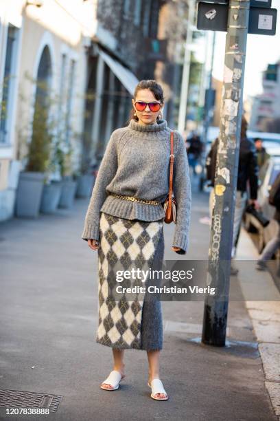 Doina Ciobanu wearing grey knit, checkered skirt is seen outside Tods during Milan Fashion Week Fall/Winter 2020-2021 on February 21, 2020 in Milan,...