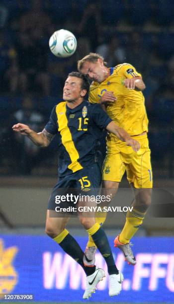 Yevhen Cheberiachko of Ukraine jumps to head the ball with Alexander Gerndt of Sweden during their international friendly soccer match between in...