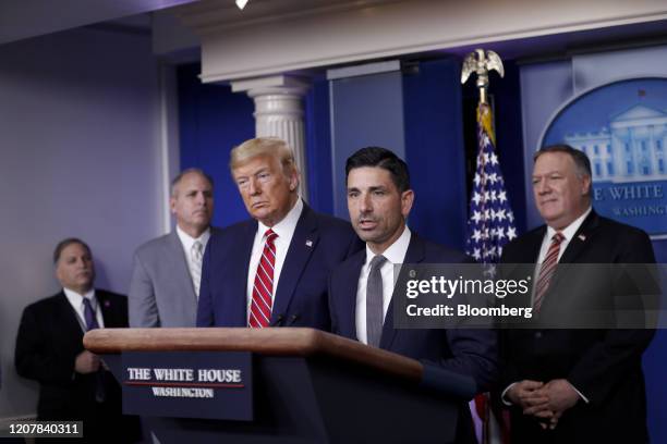 Chad Wolf, acting secretary of the Department of Homeland Security , center, speaks as U.S. President Donald Trump, third left, listens during a...