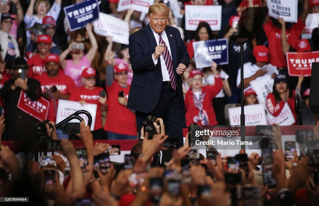 Trump Rally Backdrop President Donald Trump gestures to the crowd at a campaign rally at ...