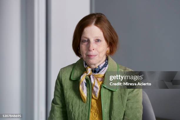 portrait of a mature caucasian woman with red hair, wears a green jacket and a yellow top, with a scarf around her neck. - yellow coat stock-fotos und bilder