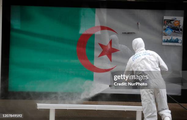 An Algerian health worker disinfects a bus stop in Algiers, Algeria, 20 March 2020. Friday prayers have been suspended in Algeria amid the spread of...