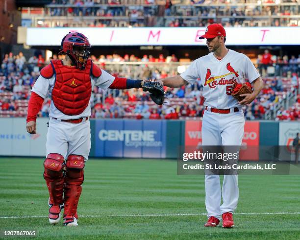 Adam Wainwright and Yadier Molina of the St. Louis Cardinals bump gloves prior to the start of the game against the Pittsburgh Pirates on May 10,...