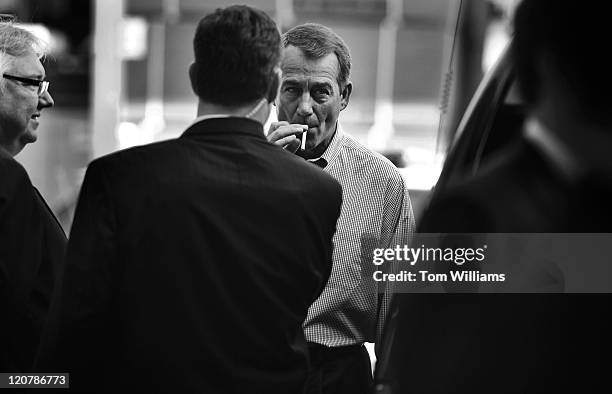 House Minority Leader John Boehner, R-Ohio, smokes a cigarette after a news conference outside of Tart Lumber Company in Sterling, Va., where...