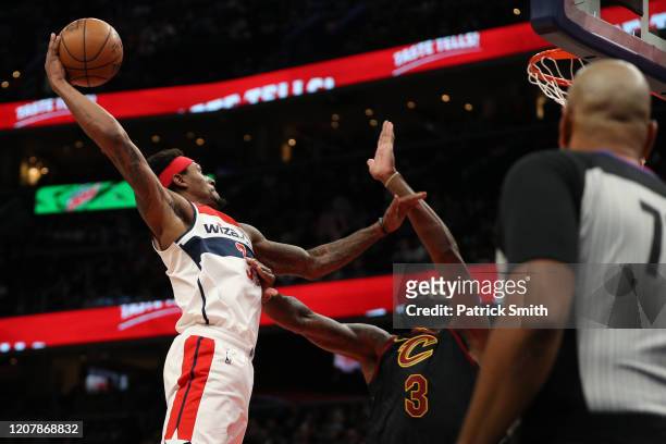 Bradley Beal of the Washington Wizards dunks on Andre Drummond of the Cleveland Cavaliers during the second half at Capital One Arena on February 21,...