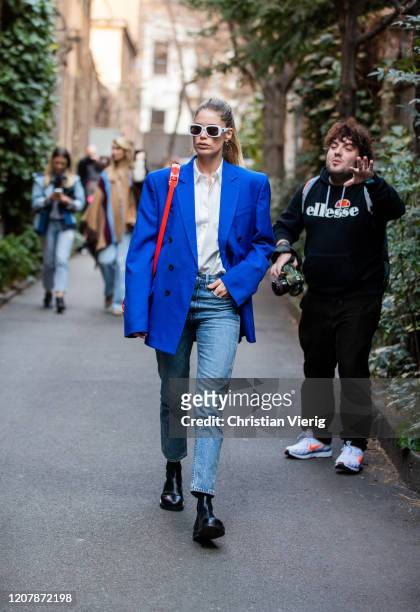 Doutzen Kroes is seen wearing white button shirt, blue oversized blazer, red bag, denim jeans outside Etro during Milan Fashion Week Fall/Winter...