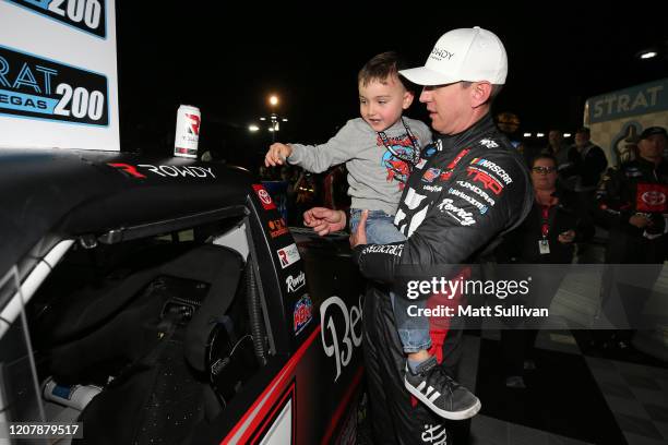 Kyle Busch, driver of the Cessna Toyota, and his son, Brexton, apply the winners sticker after the the NASCAR Gander RV & Outdoors Truck Series Strat...