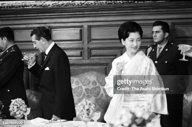 Crown Princess Michiko and Mexican President Adolfo Lopez Mateos toast glasses during their luncheon on May 12, 1964 in Mexico City, Mexico.