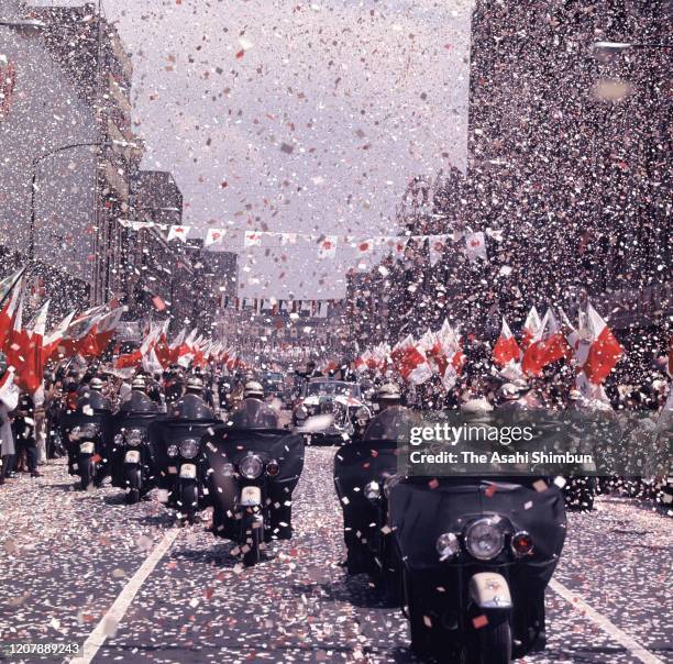 Crown Prince Akihito and Mexican President Adolfo Lopez Mateos wave to well-wishers during the welcome parade on May 11, 1964 in Mexico City, Mexico.