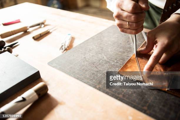 young leather craftsman making a bag - craft stock pictures, royalty-free photos & images