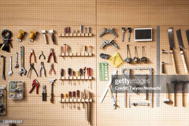 various tools arranged on the wall - instrumentos fotografías e imágenes de stock