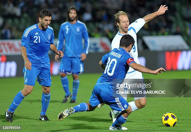 Bosnia's Zlatan Muslimovic vies for ball with Greece's Georgios Karagounis during a friendly match between the two national teams in Sarajevo, on...
