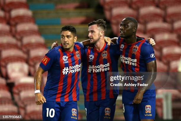 Roy O'Donovan of the Newcastle Jets celebrates his goal with team mates Dimitri Petratos and Abdiel Arroyo during the round 20 A-League match between...