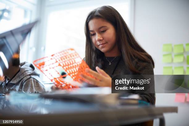 confident girl working with model for science project in training class - preteen girl models stock pictures, royalty-free photos & images