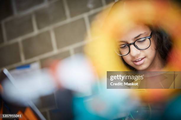 female student seen through circle in science training class - school science project foto e immagini stock