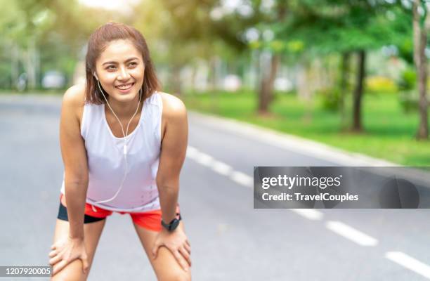 tired woman runner taking a rest after running hard in the park. sweating fitness woman tired exausted of running in sun heat dehydrated with sweat dripping from face. athlete jogger jogging outside in city. - park city background stock pictures, royalty-free photos & images