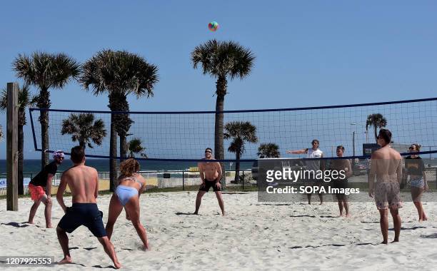 Spring breakers play volleyball during a spring break at Daytona Beach after Florida Governor Ron DeSantis refused to order the state's beaches...